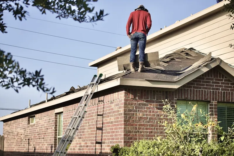 Professional roofer working on a residential roof in Topanga